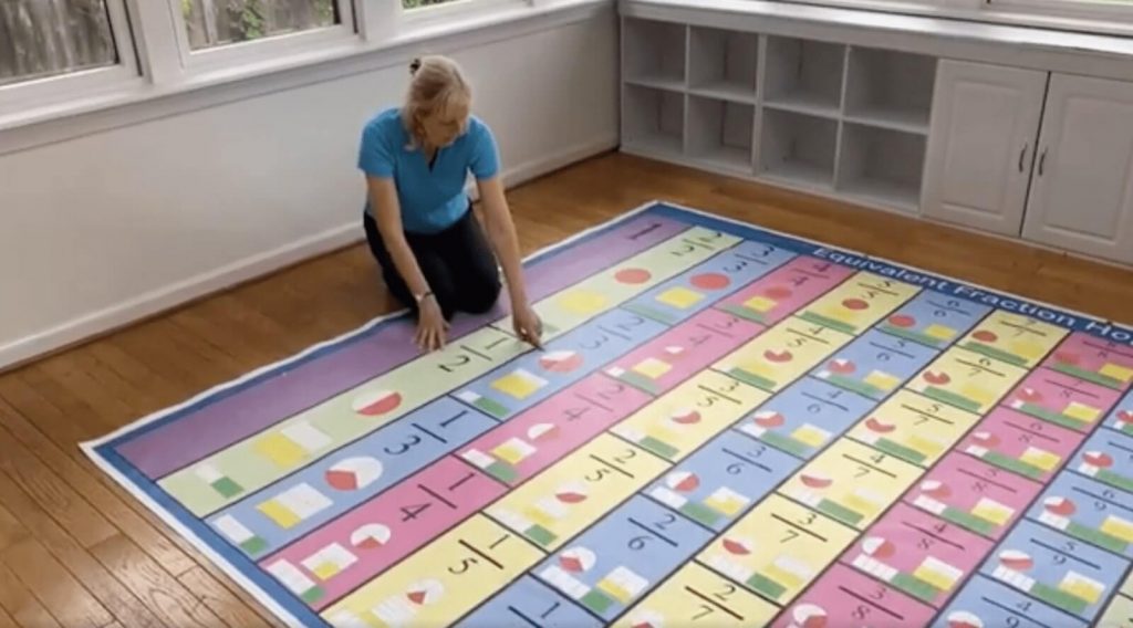Suzy using equivalent fraction mat